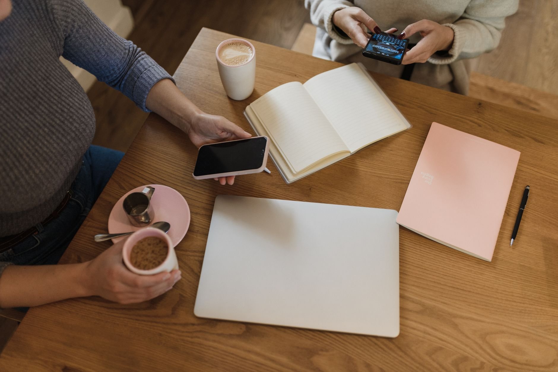 Cozy creative workspace with coffee, notebooks, and devices perfect for productivity